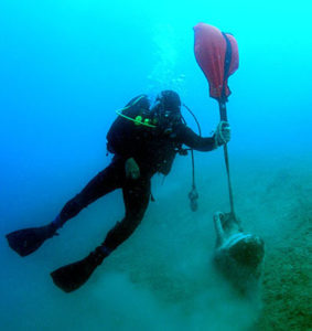 photo of diver with discovery at Butrint V site